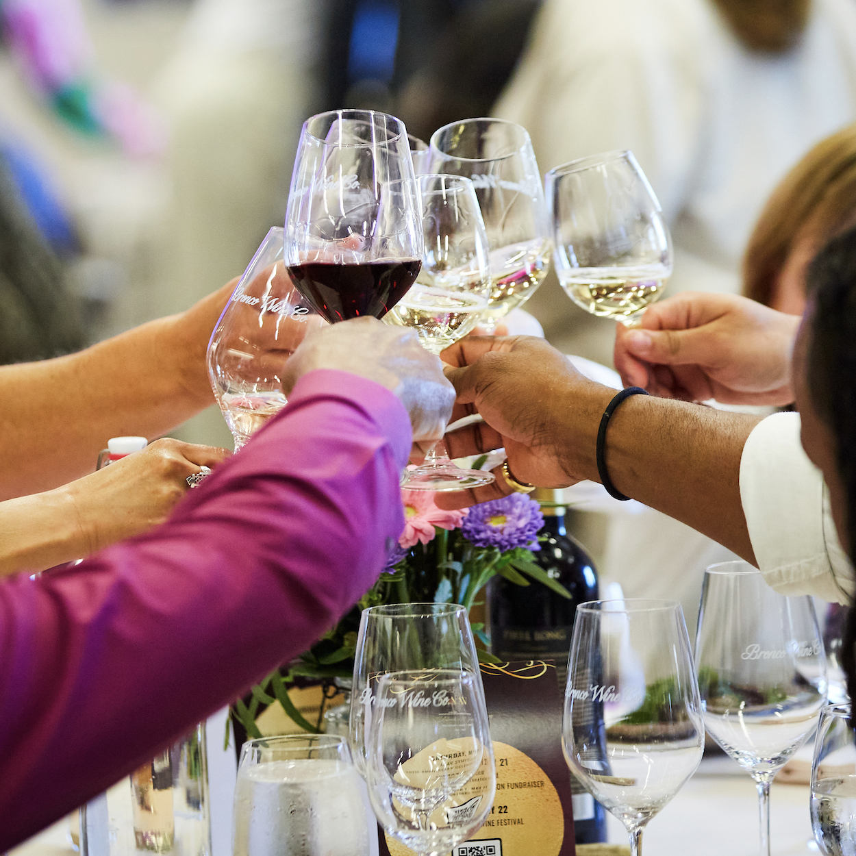 Guests raising wine glasses in a toast